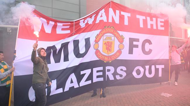 ‘Glazers out’: Manchester United fans make their feelings known outside Old Trafford overnight. Picture: Getty Images