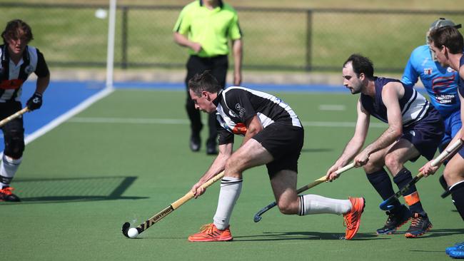 Port Adelaide’s Daniel Haynes clears the ball ahead of Forestville’s Jaykay Young during the Hockey SA Premier League season-opener. Picture: Dean Martin