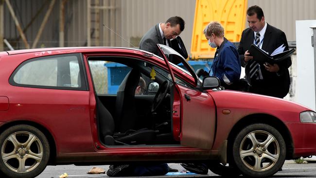 Police examine the car. Picture: Nicole Garmston