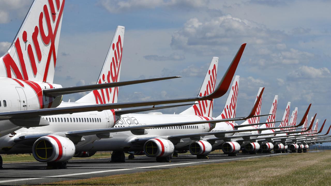 Grounded Virgin Australia aircraft are seen parked at Brisbane Airport. (AAP Image/Darren England)