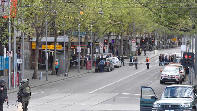 Police and bomb squad with sniffer dogs check over black rav 4 car on flinders and swanston street, Melbourne CBD where earlier a man was making threats. Picture: Jason Edwards