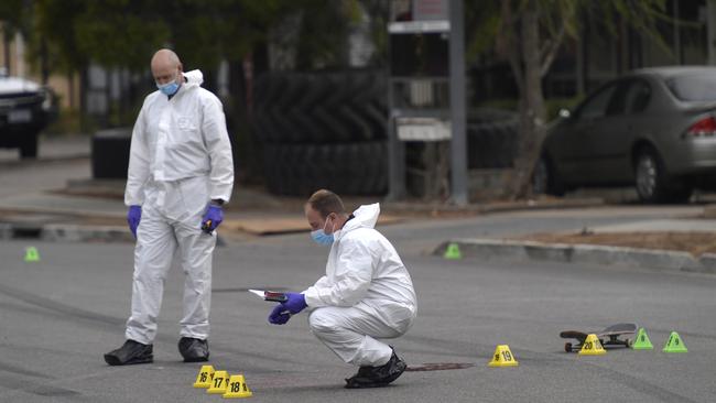 A skateboard, multiple tyre markings and a pool of blood can be seen at the crime scene. Picture: Roy VanDerVegt