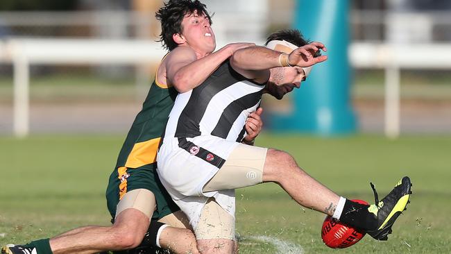 Paul Munce from Reynella is tackled by Dean Conier from Marion in a Southern Football League match this year. Marion is considering a move to the Adelaide Football League. Picture: Stephen Laffer