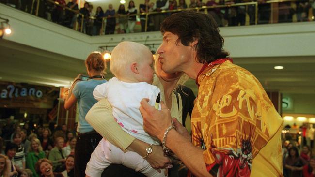 Ronn Moss kisses one-year-old Millie in 2002.