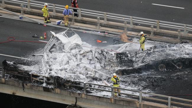 Firefighters and emergency services at the scene of the crash on the bridge over the Nerang River at Nerang. Photo: Glenn Hampson