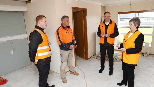 Minister for housing Roger Jaensch and Speaker Sue Hickey inside a public housing unit in Glenorchy that is getting renovated talk with project manager for Housing Tasmania, Euan Bennett and site manager for Maquarie Builders, Alex van Gelderen. Picture: Zak Simmonds