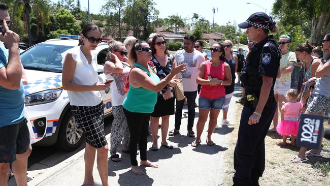 Concerned parents at the gate of Helensvale Primary School after it first went into lockdown early last year. Photograph: Jason O'Brien.