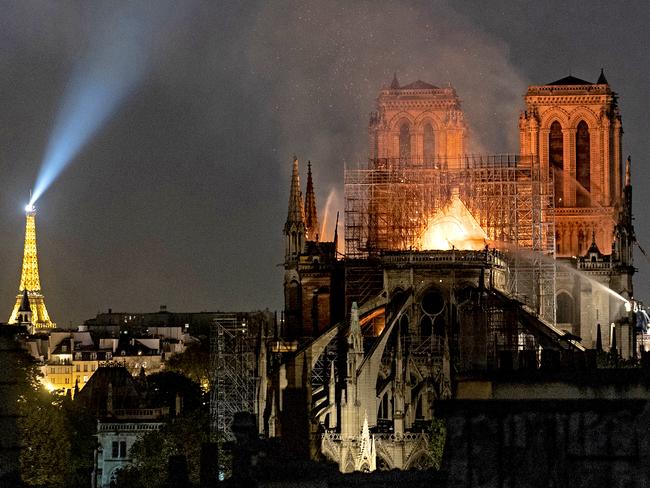 PARIS, FRANCE - APRIL 15: (EDITOR'S NOTE: Re-transmission with alternate crop) Flames and smoke are seen billowing from the roof at Notre-Dame Cathedral on April 15, 2019 in Paris, France. A fire broke out on Monday afternoon and quickly spread across the building, collapsing the spire. The cause is yet unknown but officials said it was possibly linked to ongoing renovation work. (Photo by Veronique de Viguerie/Getty Images)