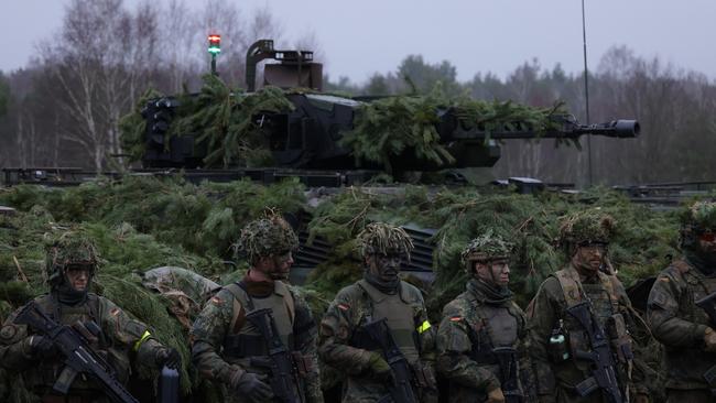 Infantry soldiers of the Bundeswehr, the German armed forces, stand in front of a Puma infantry fighting vehicle of Panzergrenadierbataillon 122, a mechanized infantry unit, during a visit by German Defence Minister Boris Pistorius at Altengrabow near Moeckern, Germany. Germany has given the green light to supplying Ukraine with heavy tanks.