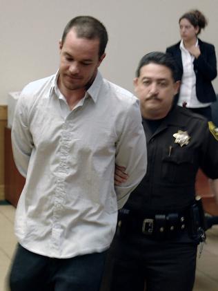 Koby Abberton, pictured being led out of court in Hawaii in 2008 after brawling with an off-duty police officer. Picture: AP/Jeff Mull.