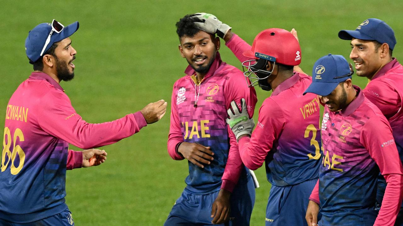 Karthik Meiyappan celebrates a wicket with his teammates. Photo by WILLIAM WEST / AFP