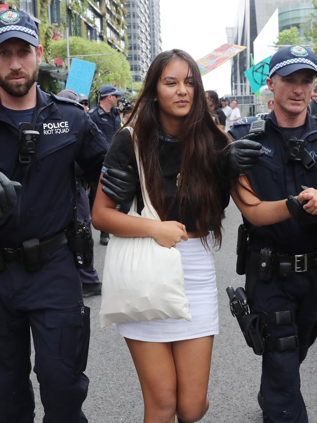 Protester Lucy Henderson is arrested on Monday. Picture: Richard Dobson