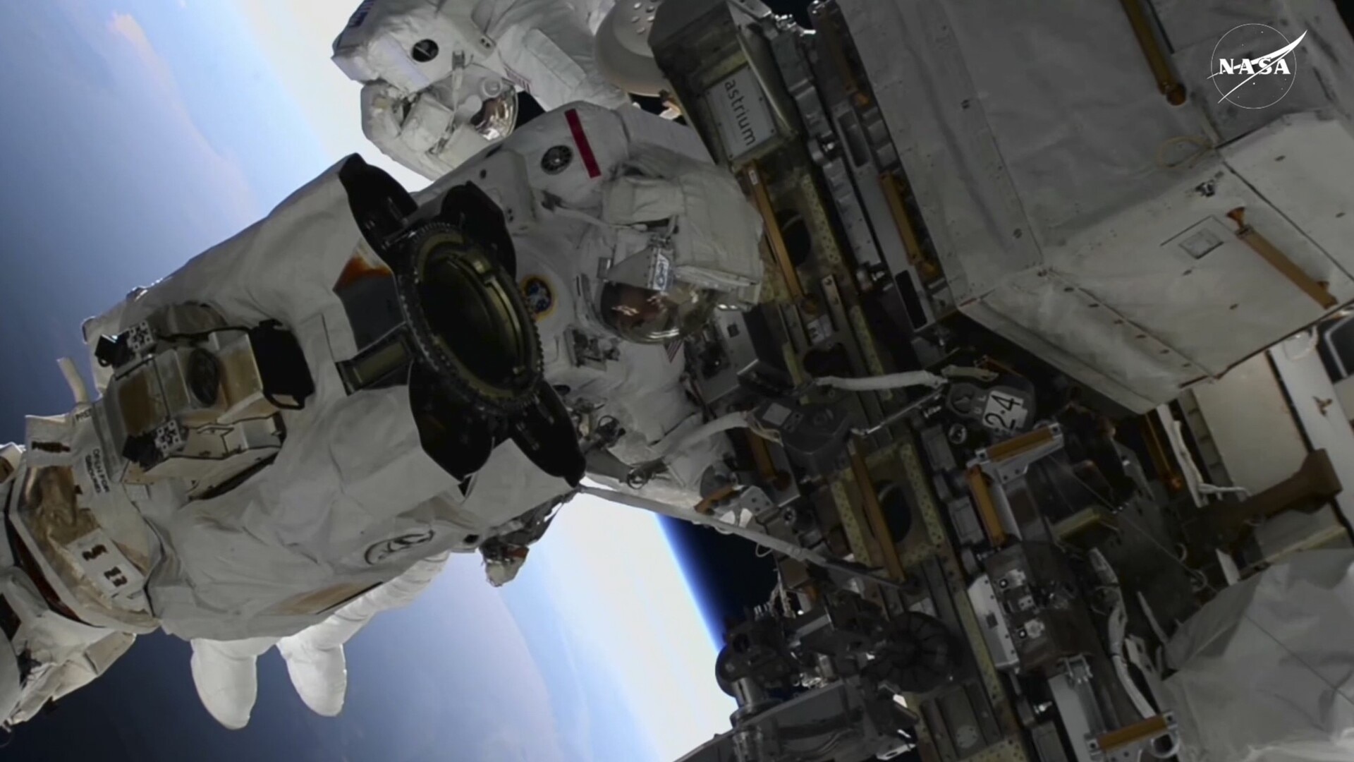 Trapped NASA astronauts complete first spacewalk