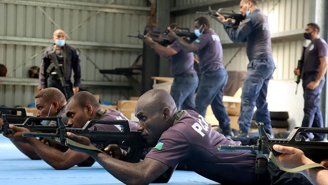 China Police Liason Team officers train local Solomon Isands officers in drill, unarmed combat skills, and rifle tactics. Picture: Royal Solomon Islands Police Force via AFP.