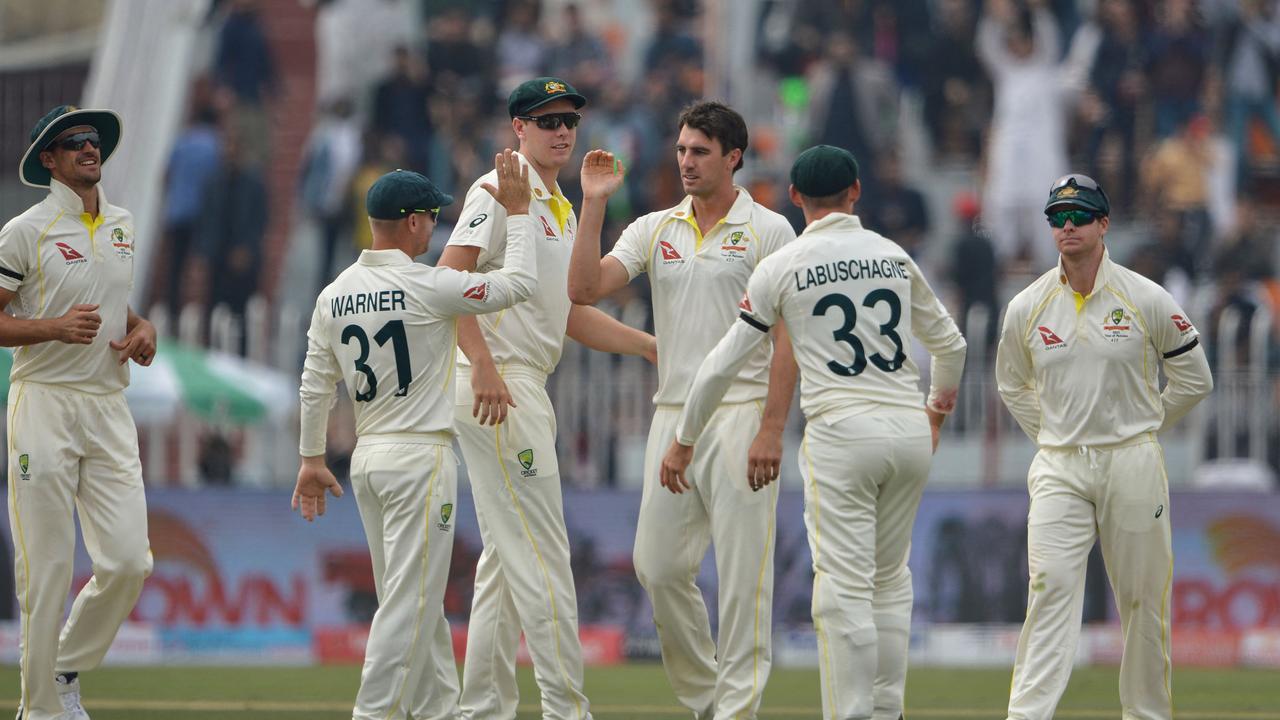 Australia's cricketers celebrate the wicket of Pakistan's Imam-ul-Haq.
