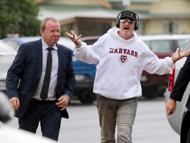 Tony Jones (in cap) flanked by Detective Sergeant Andrew Lonergan attend the inquest into William Tyrrell's disappearance at Taree Local Court in Taree, NSW, Wednesday, March 11, 2020. William Tyrrell disappeared from a Kendall property belonging to his foster grandparents on September 12, 2014. (AAP Image/Nathan Edwards)