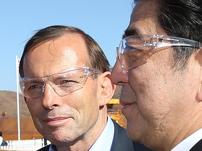 FAIRFAX AND NEWS POOL ONLY: The Prime Minister Tony Abbott and the Japanese Prime Minister Shinzo Abe with CEO Rio Tinto Sam Walsh with the chief executive Iron ore Andrew Harding during their visit to Rio TintoÕs West Angelas iron ore mine in the Pilbera, Western Australia. Michael Gollschewski hosted a tour where both PMÕs met with Rio Tinto employees, toured an exhibition and took in the view of the Centre Pit. They were photographed with a Komatsu 930E autonomous haul truck, an autonomous drill display including a walk through the control room, a Hitachi EX5600 excavator and a Bridgestone truck tyre and conveyor reel. Pic By Gary Ramage. 9th July 2014. **NO ARCHIVING**