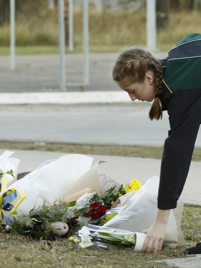 People leaving floral tributes. Picture: Jonathan Ng