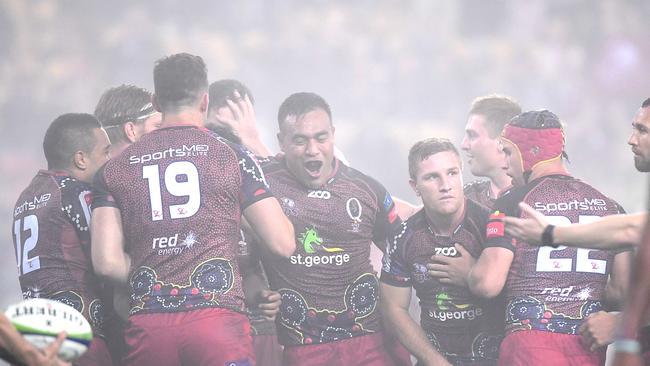 Reds players celebrate victory at Suncorp Stadium.