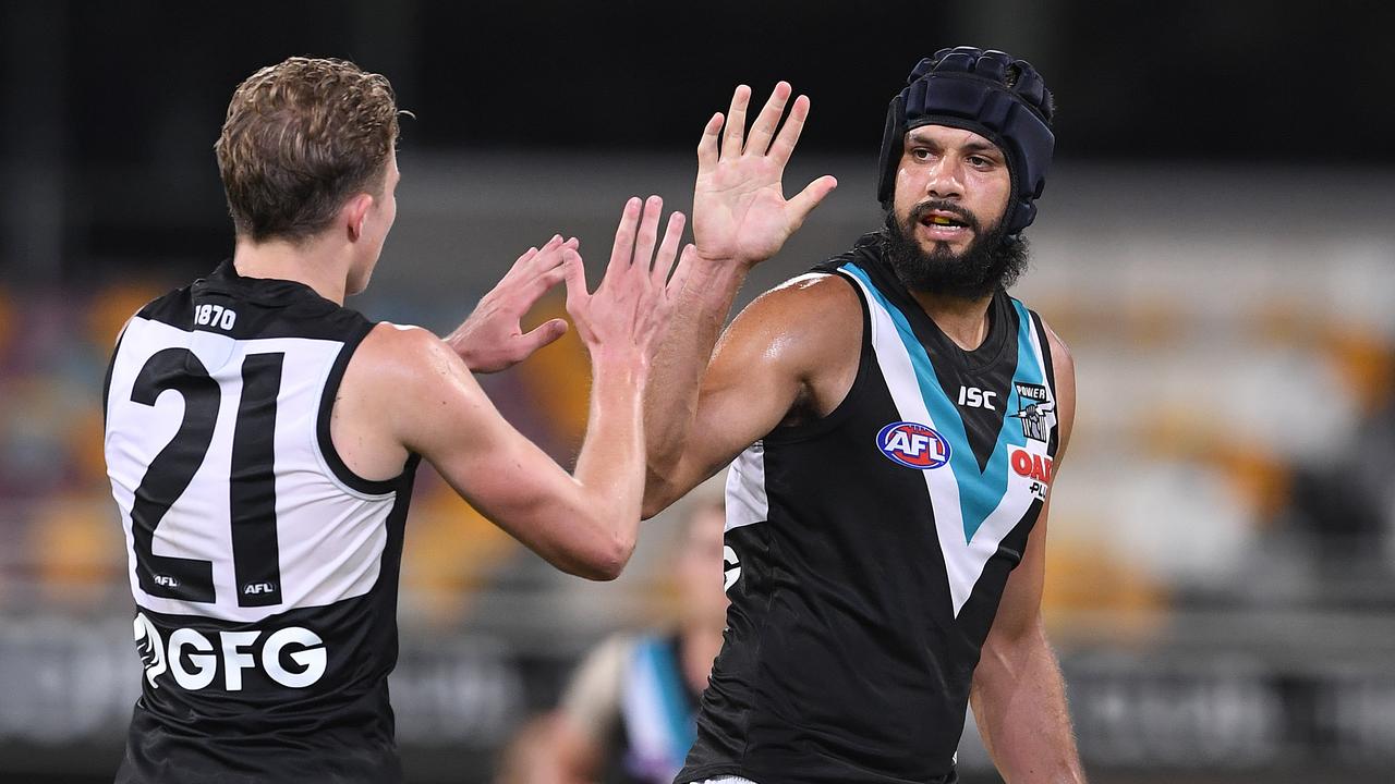 Paddy Ryder of the Power (right) reacts after kicking a goal during the Round 3 AFL match between the Brisbane Lions and Port Adelaide Power at the Gabba in Brisbane, Saturday, April 6, 2019. (AAP Image/Dave Hunt) NO ARCHIVING, EDITORIAL USE ONLY