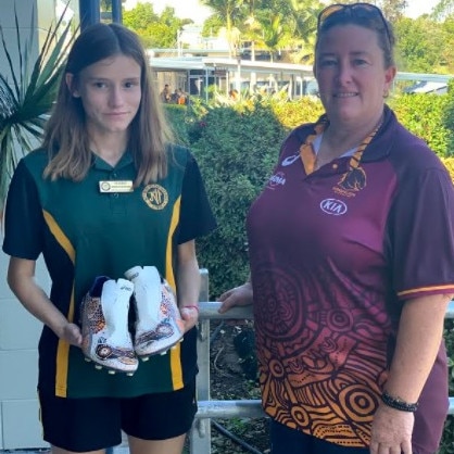 James Nash student Laurel Scammell was selected to paint a pair of Tyson Gamble's boots for the NRL's 2021 Indigenous Round. She is pictured with Nash Beyond the Broncos coordinator, Trina McCauley.