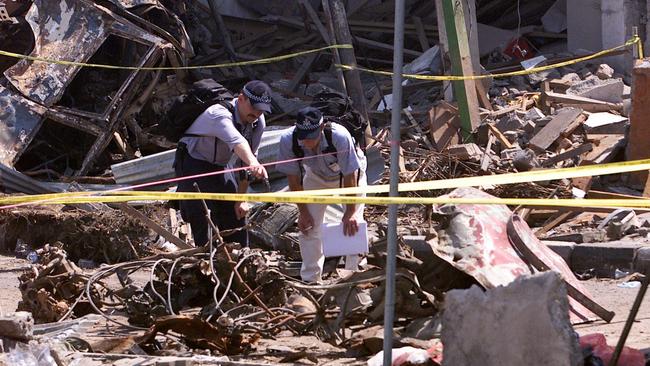 Australian forensics search through the explosion site after a bomb destroyed a nightclub in Kuta. Looking at what was possibly the car used to carry the bomb.