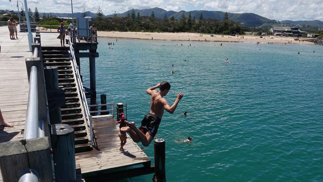 Domestic tourism has contributed considerably to Coffs’ coffers. Jayden Coombes from Arrawarra takes the plunge at The Jetty. Picture: Chris Knight