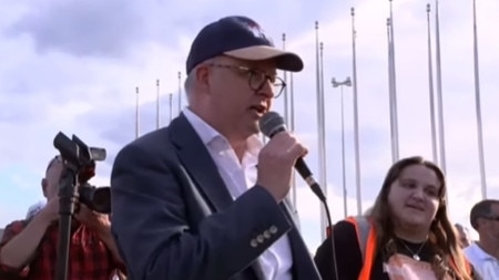 Albanese speaks at the rally, as Sarah Williams reacts.