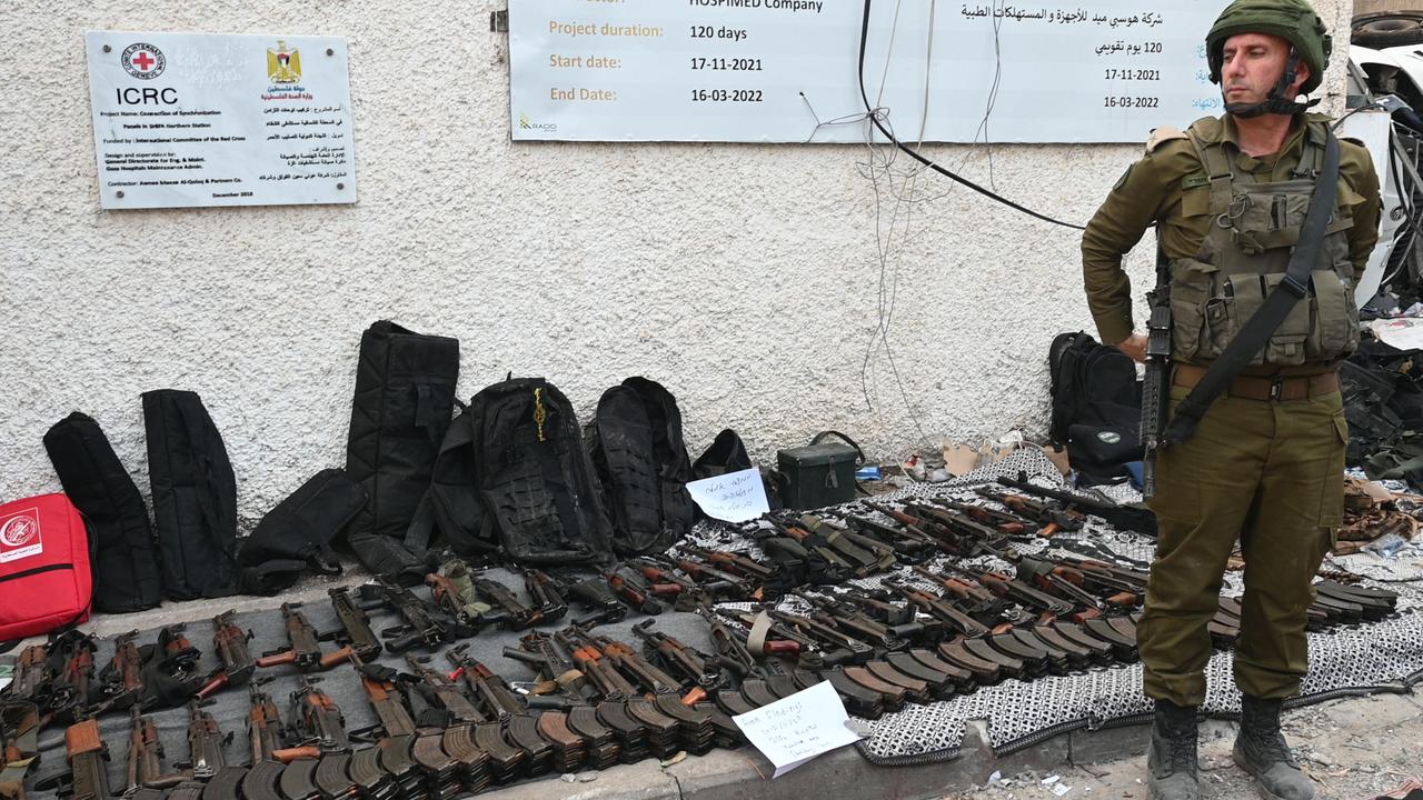 IDF spokesman Daniel Hagari stands next to an array of weapons Israel claims were left behind by Hamas militants inside al-Shifa hospital. Picture: Ahikam Seri/AFP