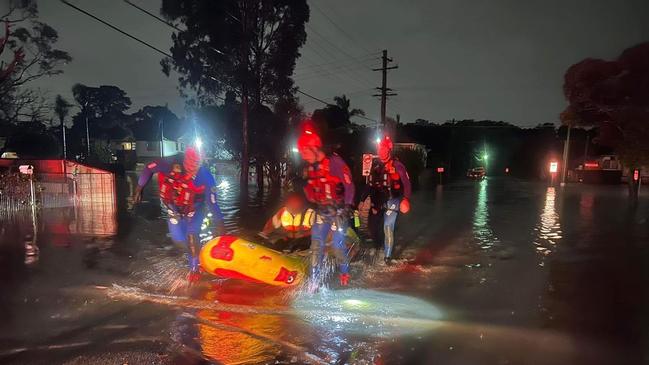 A resident is evacuated by raft from a property in Lansvale overnight. Picture: NSW SES