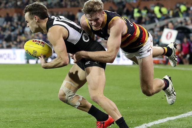 Adelaide Crows Alex Keath tackles Port Adelaide Power’s Karl Amon in Showdown 46 at Adelaide Oval. Picture Sarah Reed