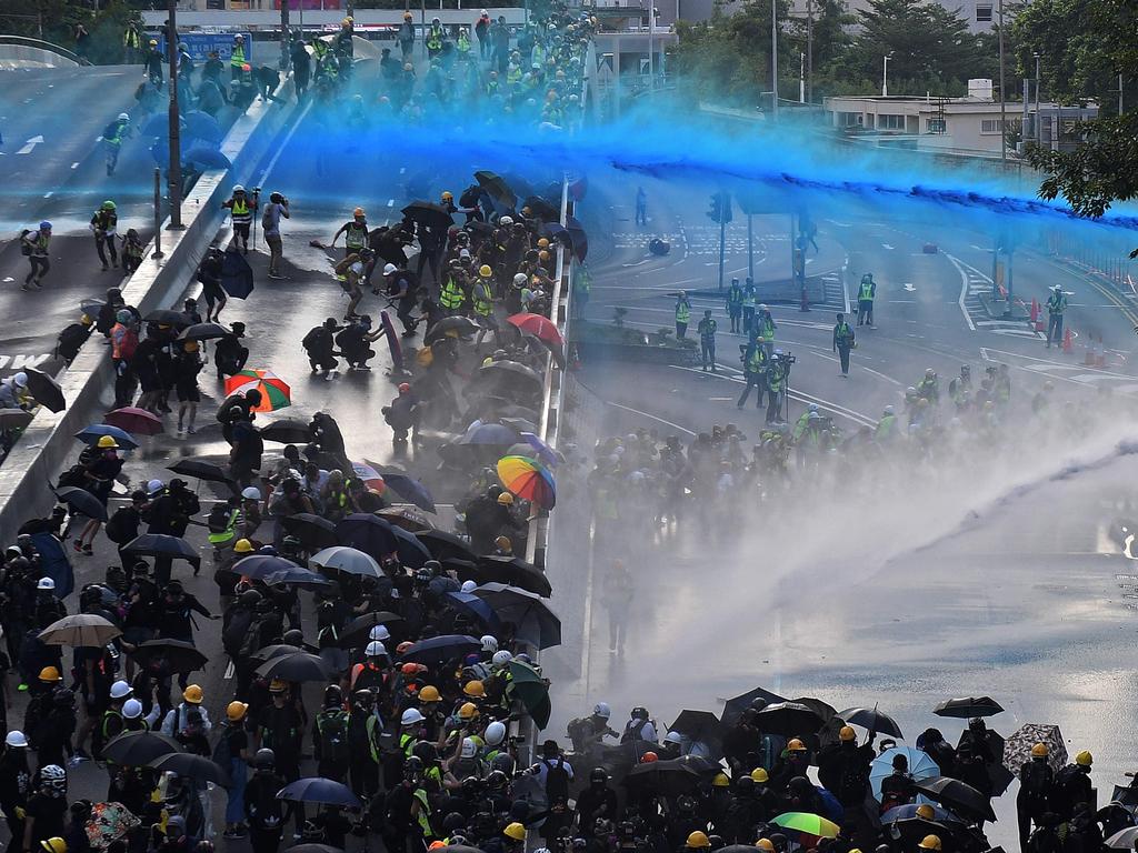 Water cannons firing blue-dyed jets have been used to quell pro-democracy protesters but have now struck a place of worship. Picture: AFP