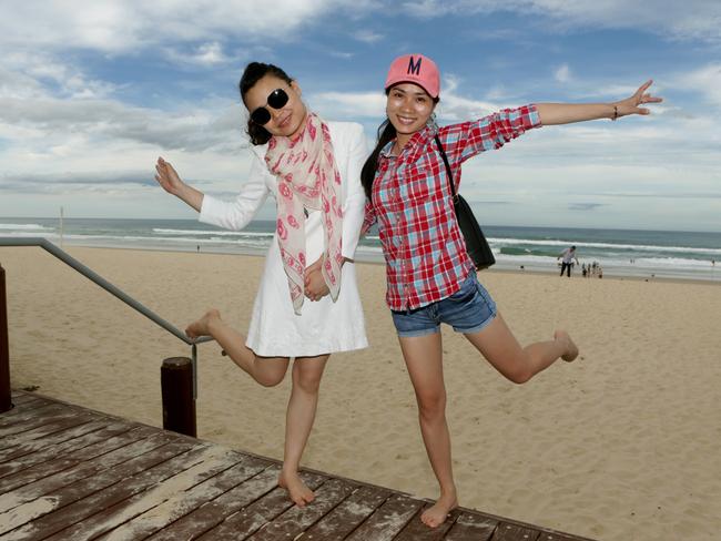 Chinese tourists on the beach at Main Beach on the Gold Coast. Pic Tim Marsden