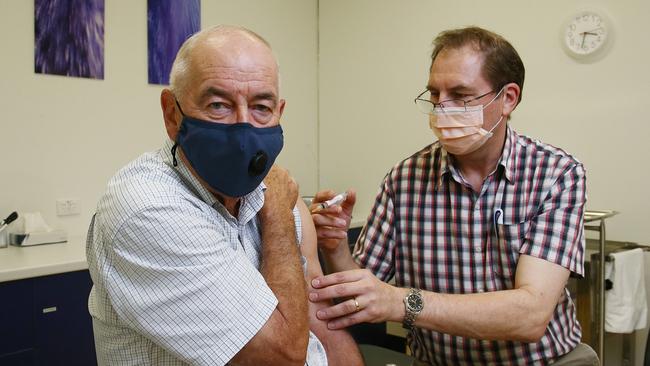 Geoff Isaacs receives a dose of the AstraZeneca COVID-19 vaccine from general practitioner Dr. Anthony Kresevic at the Edmonton Family Medical Centre. Picture: Brendan Radke