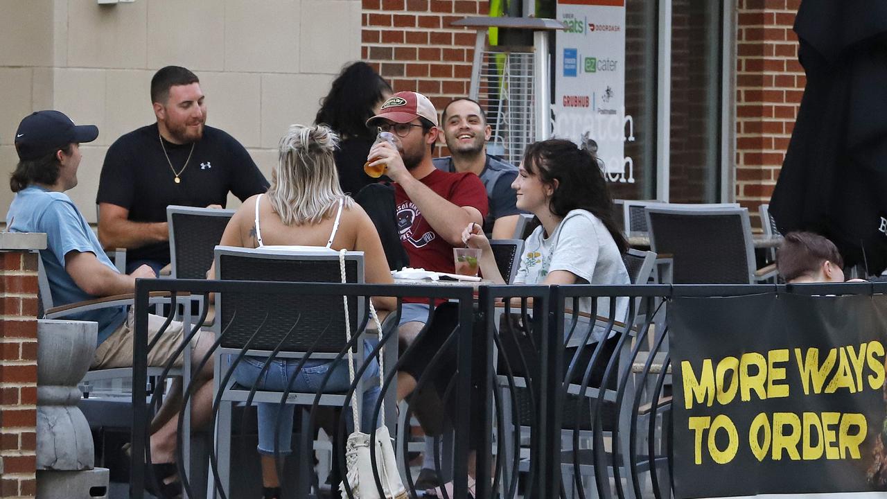 People gather at tables outside in Pittsburgh, Pennsylvania, where there’s been over 6500 deaths. Picture: AP Photo/Gene J. Puskar.