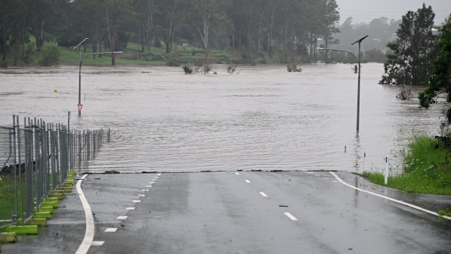 A road is cut off by floodwater in Ipswich, Queensland on Friday morning. Picture: Dan Peled/Getty Images