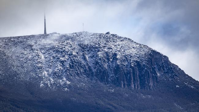 Kunanyi, Mt Wellington appeared briefly this morning to show a fresh coating of snow. Picture Eddie Safarik