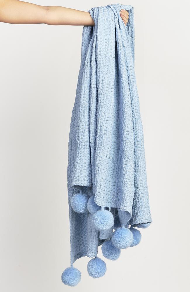 Anyone for a pompom throw rug? It will cost you $56.
