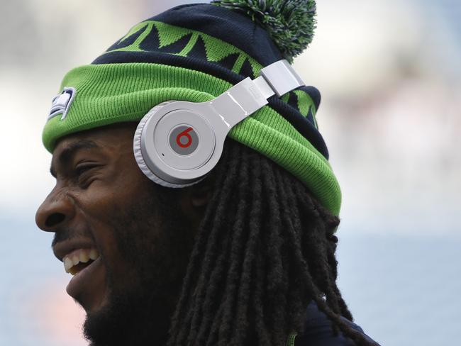 Seattle Seahawks' Richard Sherman wears Beats headphones. Beats was purchased by Apple earlier this year.