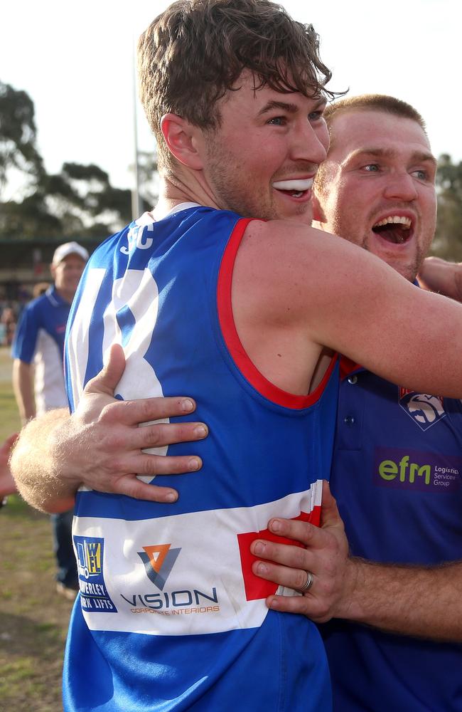 Matt Jones and coach Leigh Adams celebrate South Croydon’s stirring premiership in 2017.