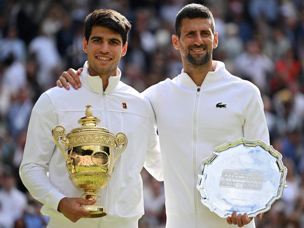 Spain's Carlos Alcaraz holding the winner's trophy (L) and second-placed Serbia's Novak Djokovic pose for pictures during the price ceremony at the end of their men's singles final. Picture: AFP