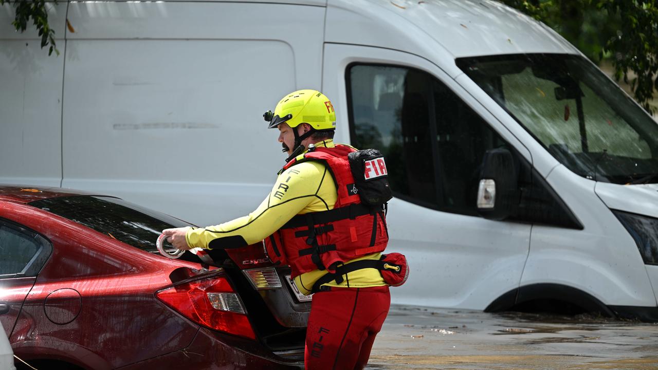 1/122024: Flash flooding in Hanlon Park, rapidly flooded around 10 cars, as police and fire and rescue check the cars are empty, Stones Corner, Brisbane. pic: Lyndon Mechielsen/Courier Mail