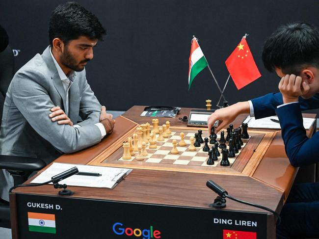 Chinaâs chess grandmaster Ding Liren (R) and Indiaâs chess grandmaster Gukesh Dommaraju (L) compete during the start of the FIDE World Chess Championship in Singapore on November 25, 2024. (Photo by Roslan RAHMAN / AFP)