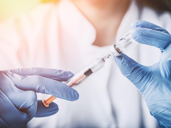 Gold Coast Suns - Coolangatta Medical Centre.injecting injection vaccine vaccination medicine flu man doctor insulin health drug influenza concept - stock image