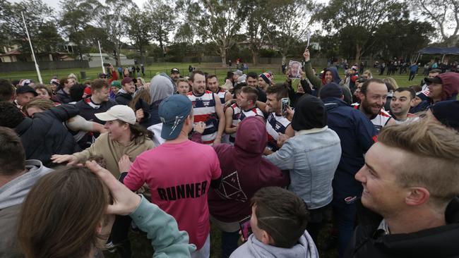 Supporters converge on players after the final siren.