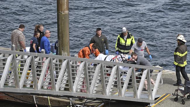 Emergency response crews transport an injured passenger to an ambulance at the George Inlet Lodge docks in Ketchikan, Alaska, after the accident. Picture: AP/Dustin Safranek