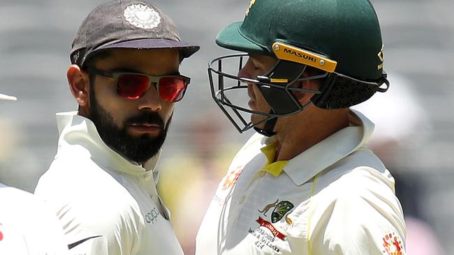 Kohli and Aussie captain Tim Paine get up close and personal. Picture: Getty Images