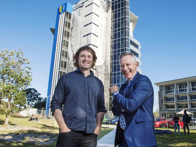 Internationally renowned mural artist Guido van Helten and Vice Chancellor Professor Adam Shoemaker in front of the large scale artwork on a building at Southern Cross University Gold Coast campus. Picture: Elise Derwin