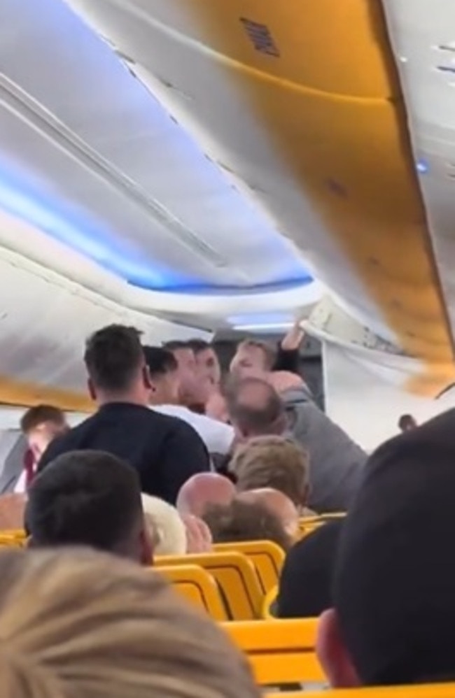 A seated passenger the stands up and punches the man in the face. Picture: Facebook/Canal 4 Tenerife