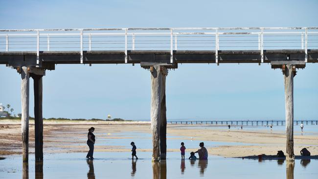 People enjoying the shade under the Largs Bay jetty. (AAP Image/Brenton Edwards)